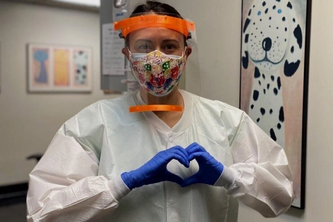 Healthcare worker with heart hands